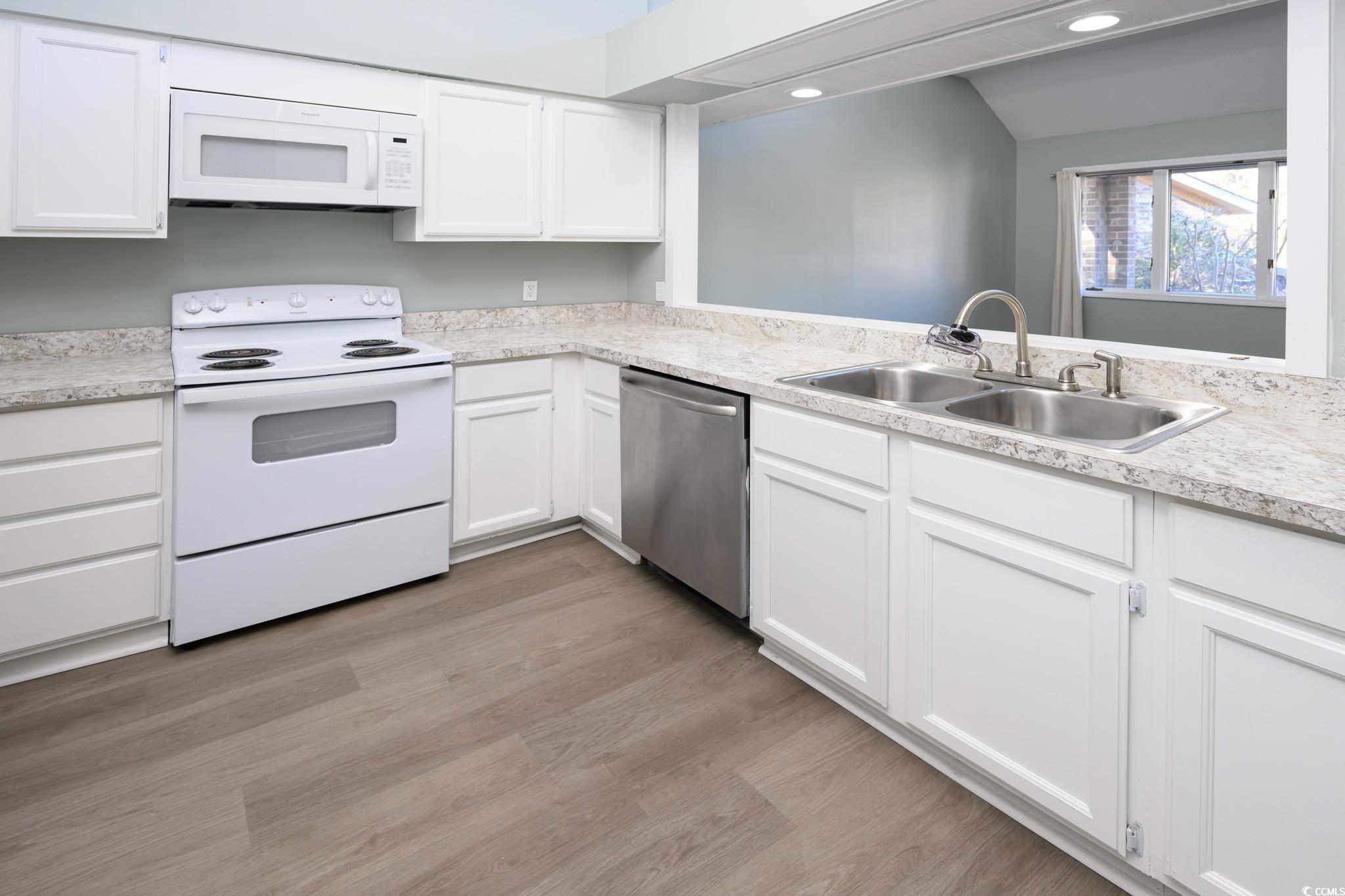 1841 Fairway Ridge Drive, Unit 5H Myrtle Beach, SC 29575 - Photo 5 of 22 Kitchen with white cabinets, light wood-type floor