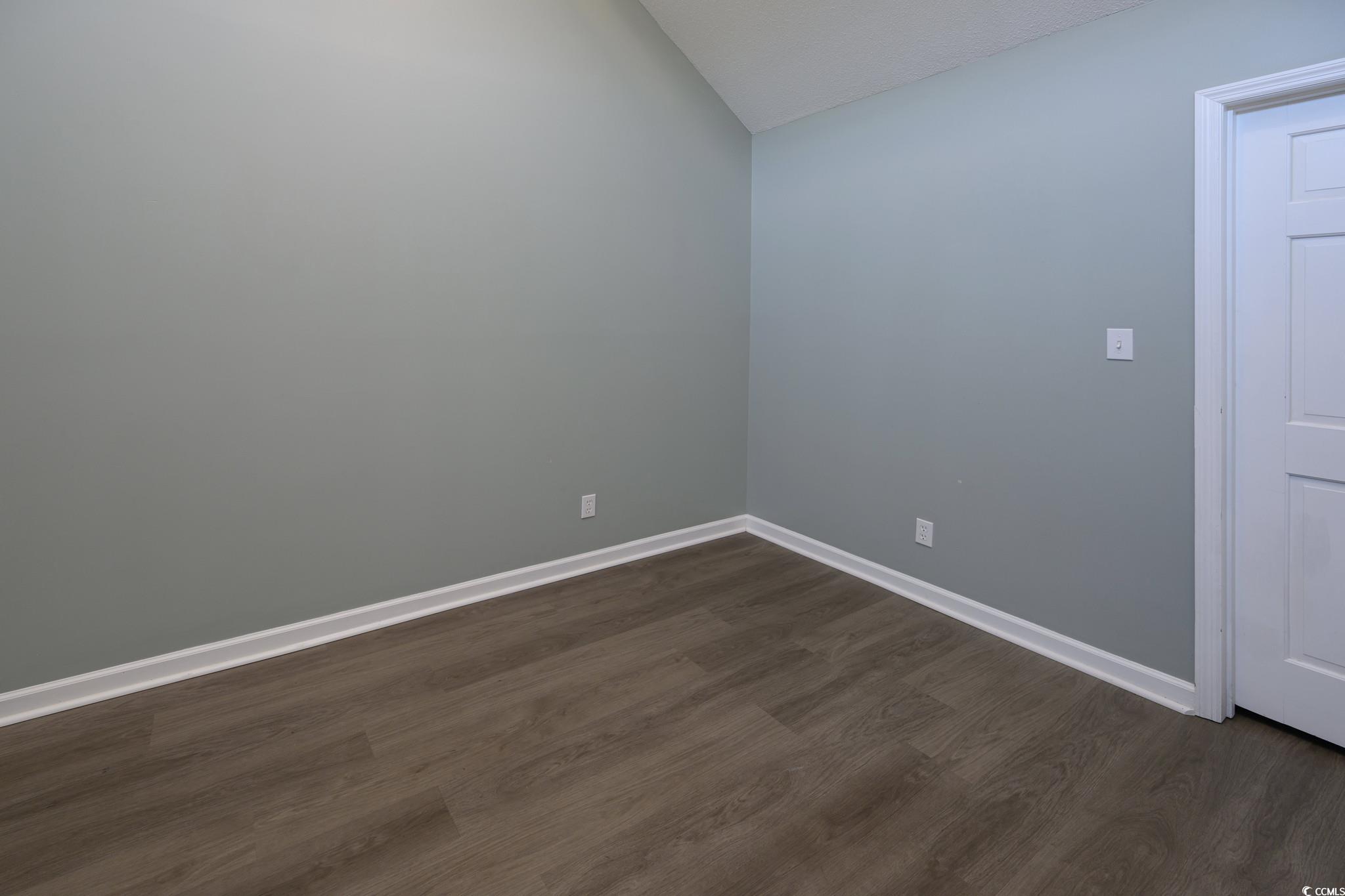 1841 Fairway Ridge Drive, Unit 5H Myrtle Beach, SC 29575 - Photo 9 of 22 Empty room featuring dark hardwood / wood-style fl