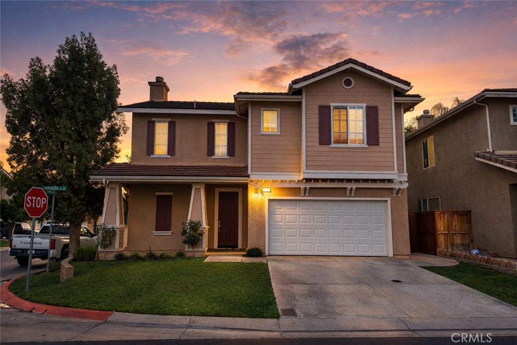 a front view of a house with a yard and garage