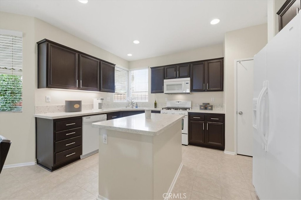 4674 Trailmore Court Riverside, CA 92505 - Photo 14 of 45 a kitchen with stainless steel appliances a stove sink microwave and cabinets