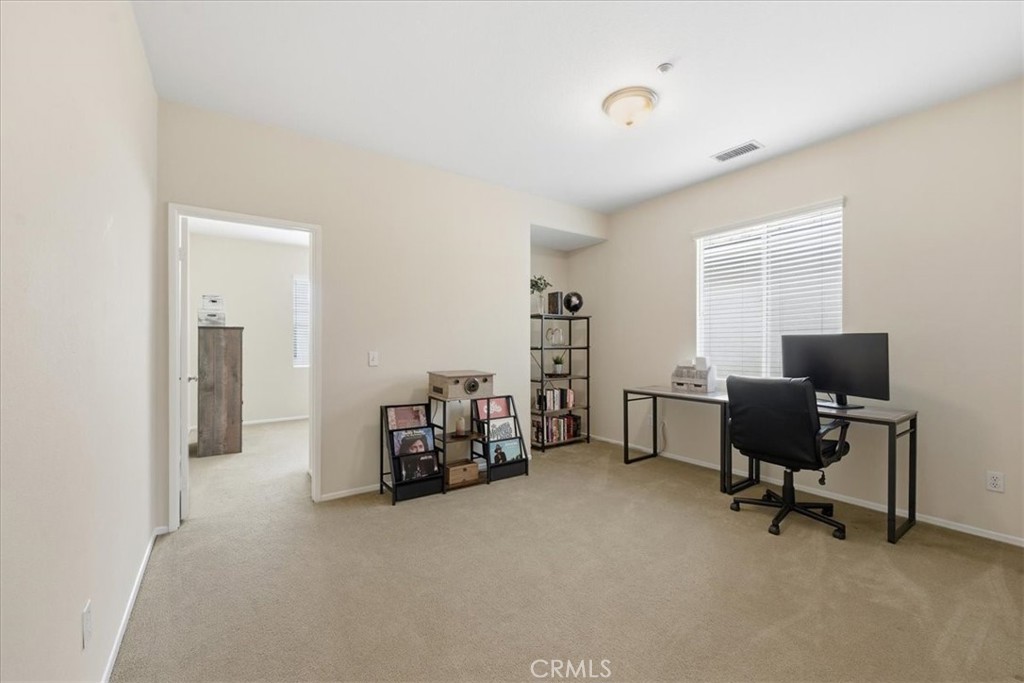 4674 Trailmore Court Riverside, CA 92505 - Photo 18 of 45 a view of a livingroom with workspace and a window
