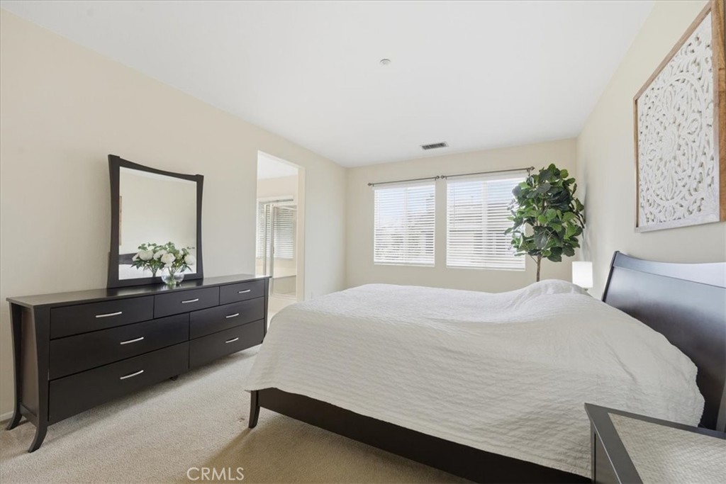 4674 Trailmore Court Riverside, CA 92505 - Photo 20 of 45 a bedroom with a bed and a dresser