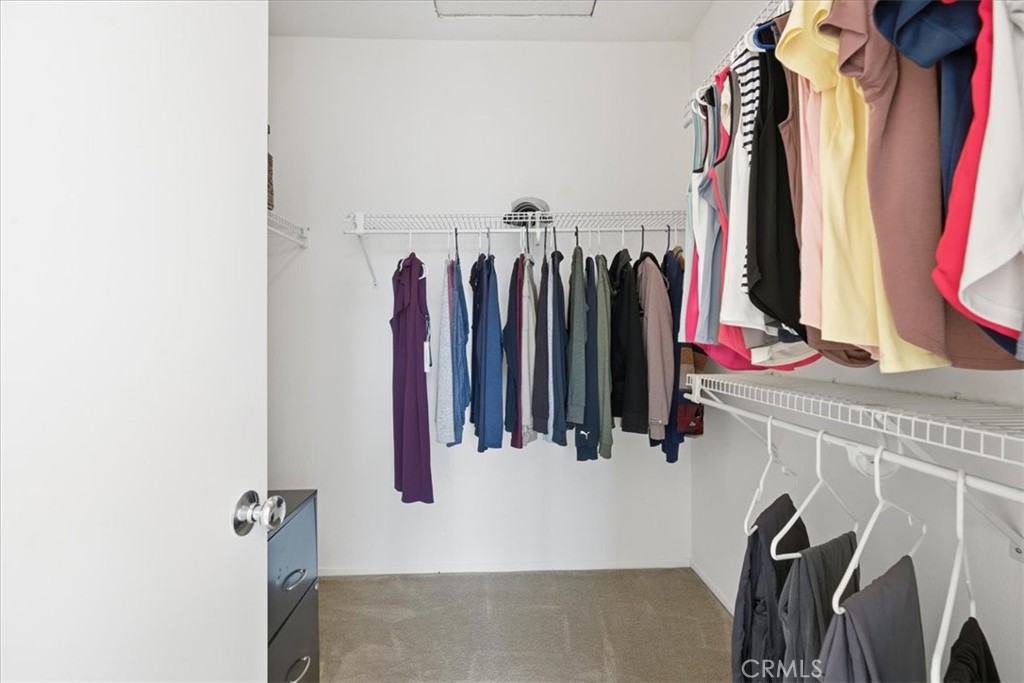 4674 Trailmore Court Riverside, CA 92505 - Photo 24 of 45 a view of walk in closet with clothes