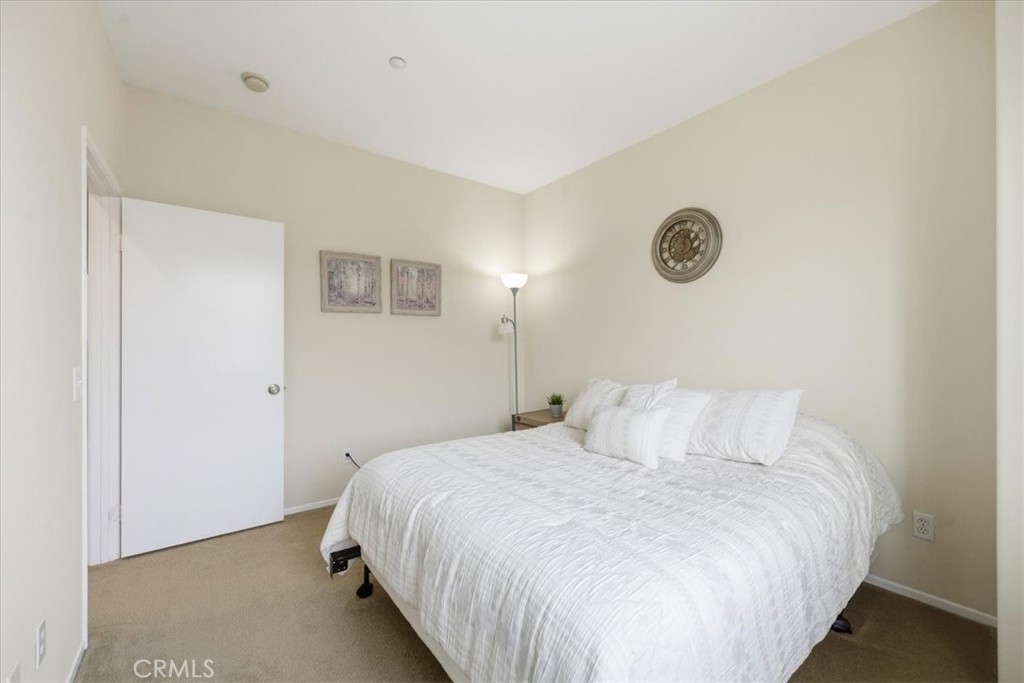 4674 Trailmore Court Riverside, CA 92505 - Photo 25 of 45 a bedroom with a bed and a window