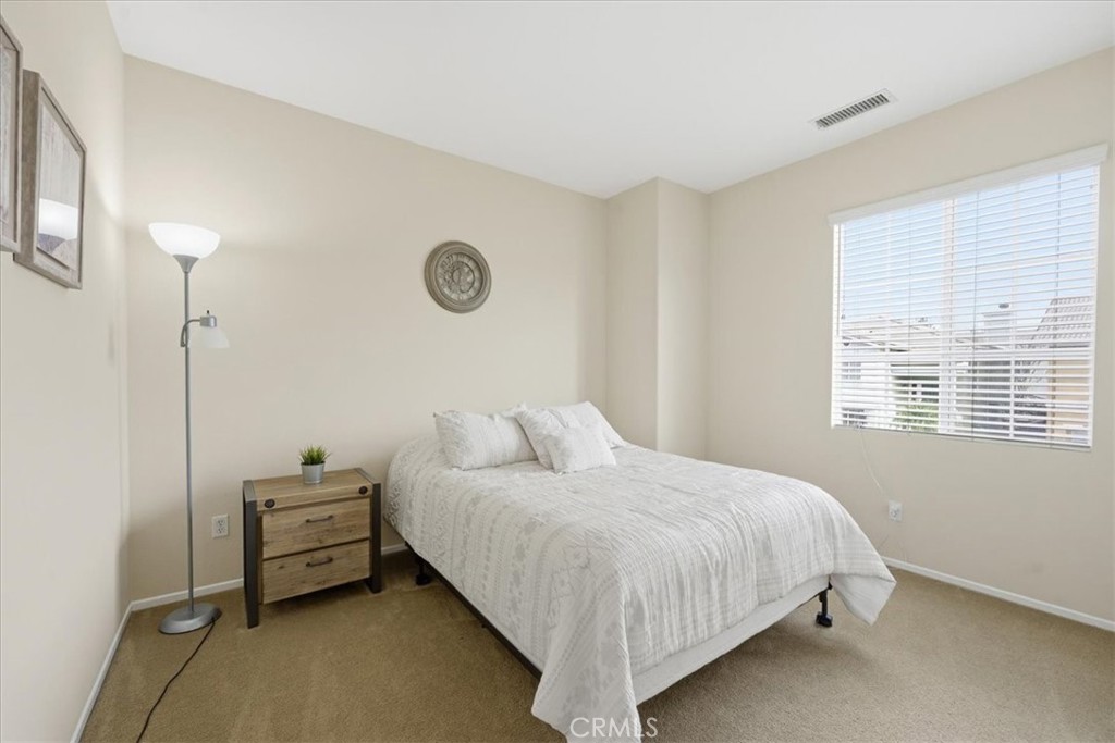 4674 Trailmore Court Riverside, CA 92505 - Photo 26 of 45 a bedroom with a bed and a window
