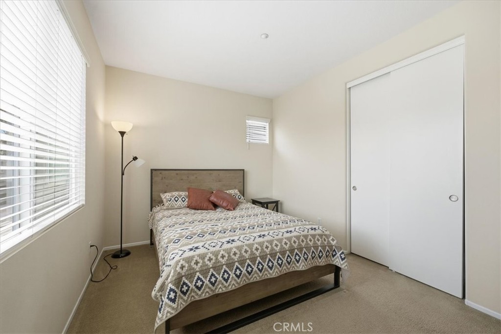 4674 Trailmore Court Riverside, CA 92505 - Photo 27 of 45 a bedroom with a bed and a window