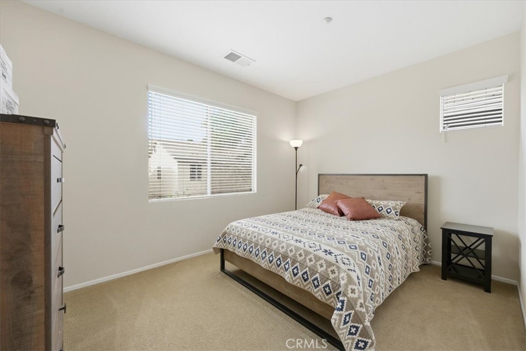 4674 Trailmore Court Riverside, CA 92505 - Photo 28 of 45 a bedroom with a bed and a window
