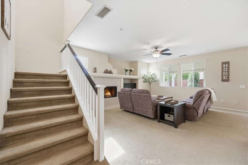 4674 Trailmore Court Riverside, CA 92505 - Photo 7 of 45 a living room with furniture and a stair