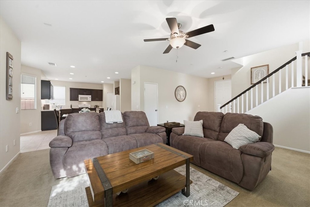 4674 Trailmore Court Riverside, CA 92505 - Photo 10 of 45 a living room with furniture kitchen view and a chandelier