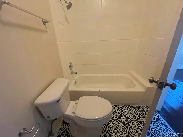 a bathroom with a toilet and a bathtub