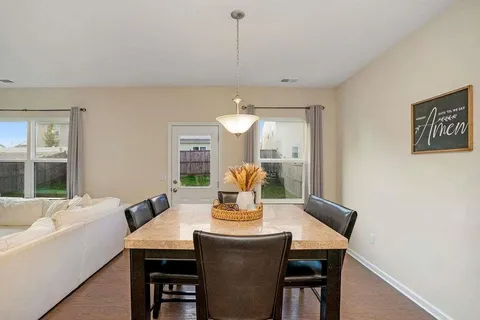 a view of a dining room with furniture window and outside view