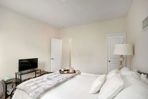 a bedroom with a bed and a flat screen tv