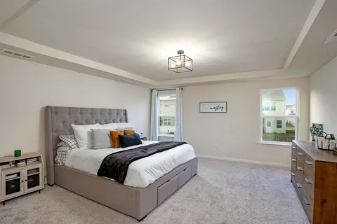 a bedroom with a bed and a table with lamp