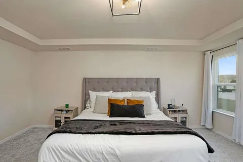 a bedroom with a bed and window