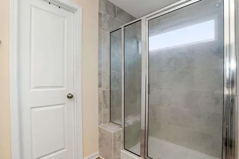 a bathroom with a glass shower door