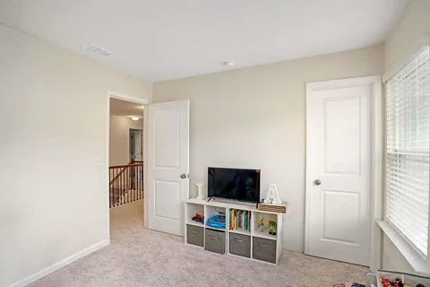 a view of a livingroom with furniture and a flat screen tv