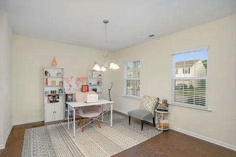 a work room with furniture and a chandelier