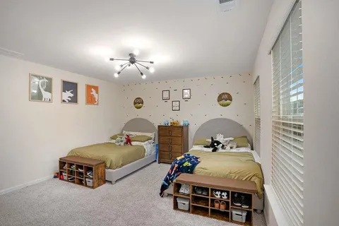 a bedroom with bed and window