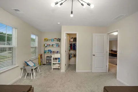 a view of a livingroom with furniture and staircase
