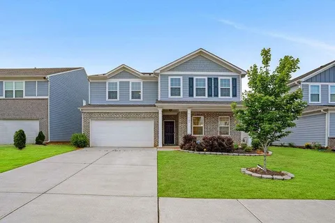 a front view of house with yard and green space
