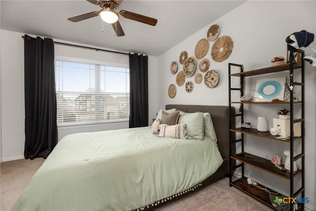 a bedroom with a bed and dresser with mirror
