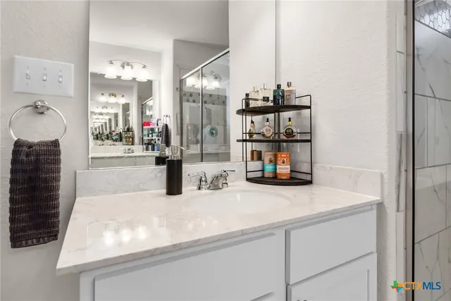 a kitchen with kitchen island a sink appliances and cabinets