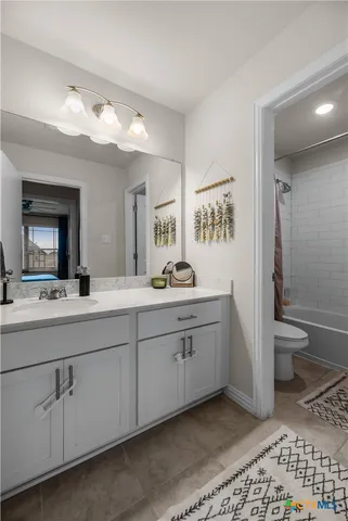 a spacious bathroom with a double vanity sink mirror and toilet
