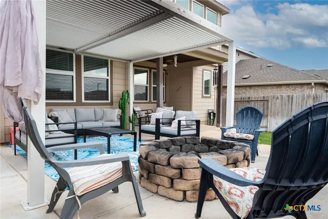 a outdoor living space with patio furniture and a fireplace