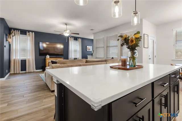 a kitchen with kitchen island a counter space a sink and appliances
