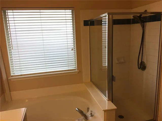 a bathroom with a shower and a window