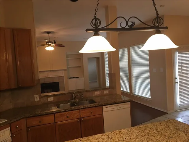 a kitchen with a sink and cabinets