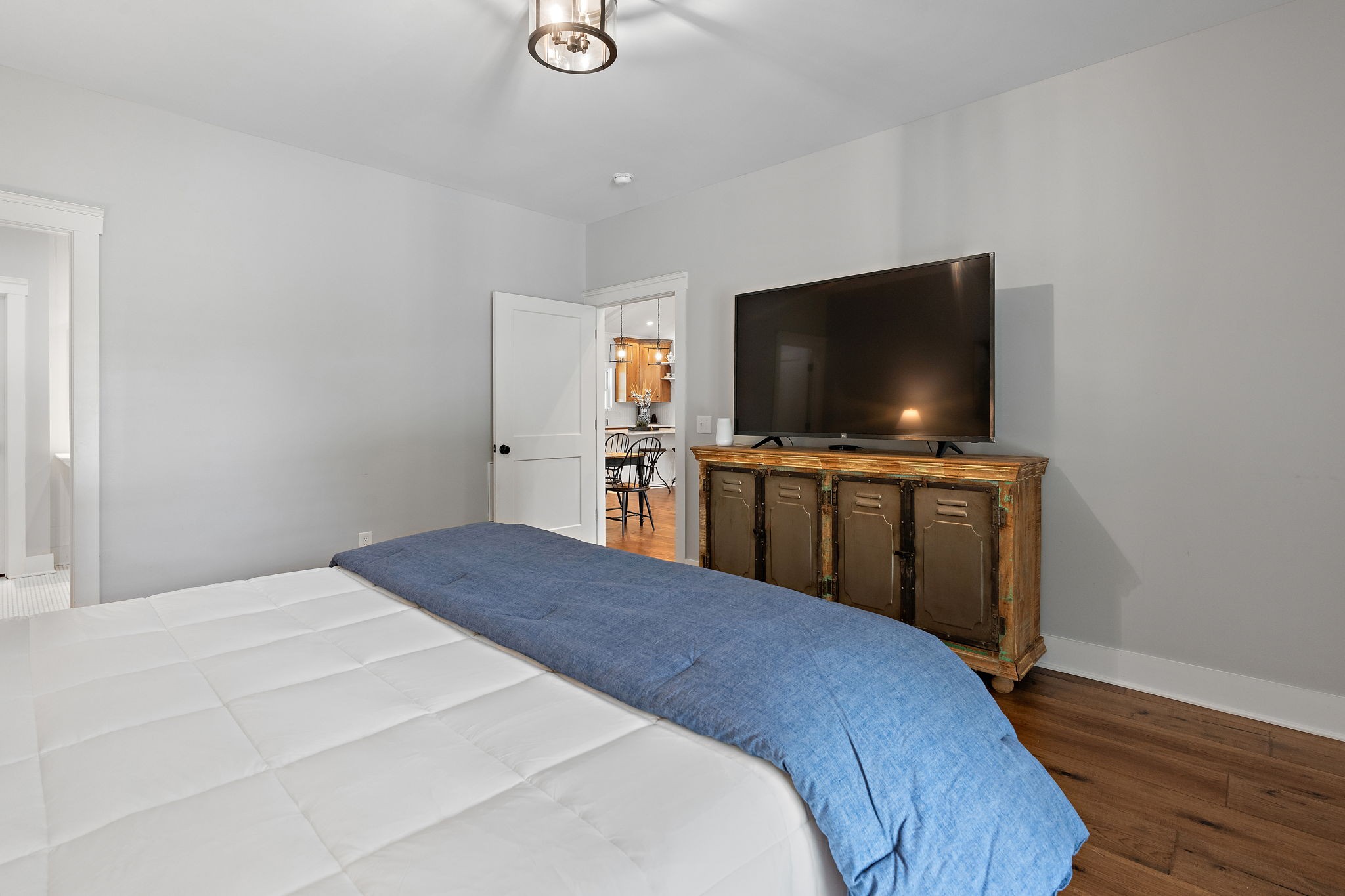 2379 White Bluff Road Burns, TN 37029 - Photo 13 of 40 a bedroom with a bed and a flat screen tv