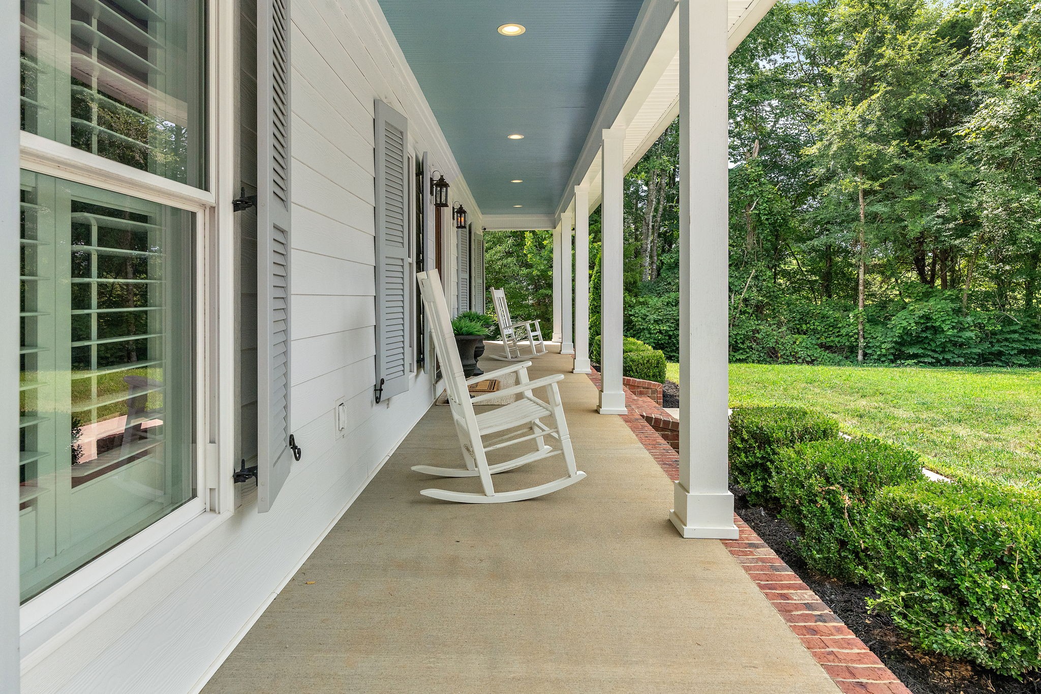 2379 White Bluff Road Burns, TN 37029 - Photo 3 of 40 a view of a patio with lawn chairs floor to ceiling window and garden
