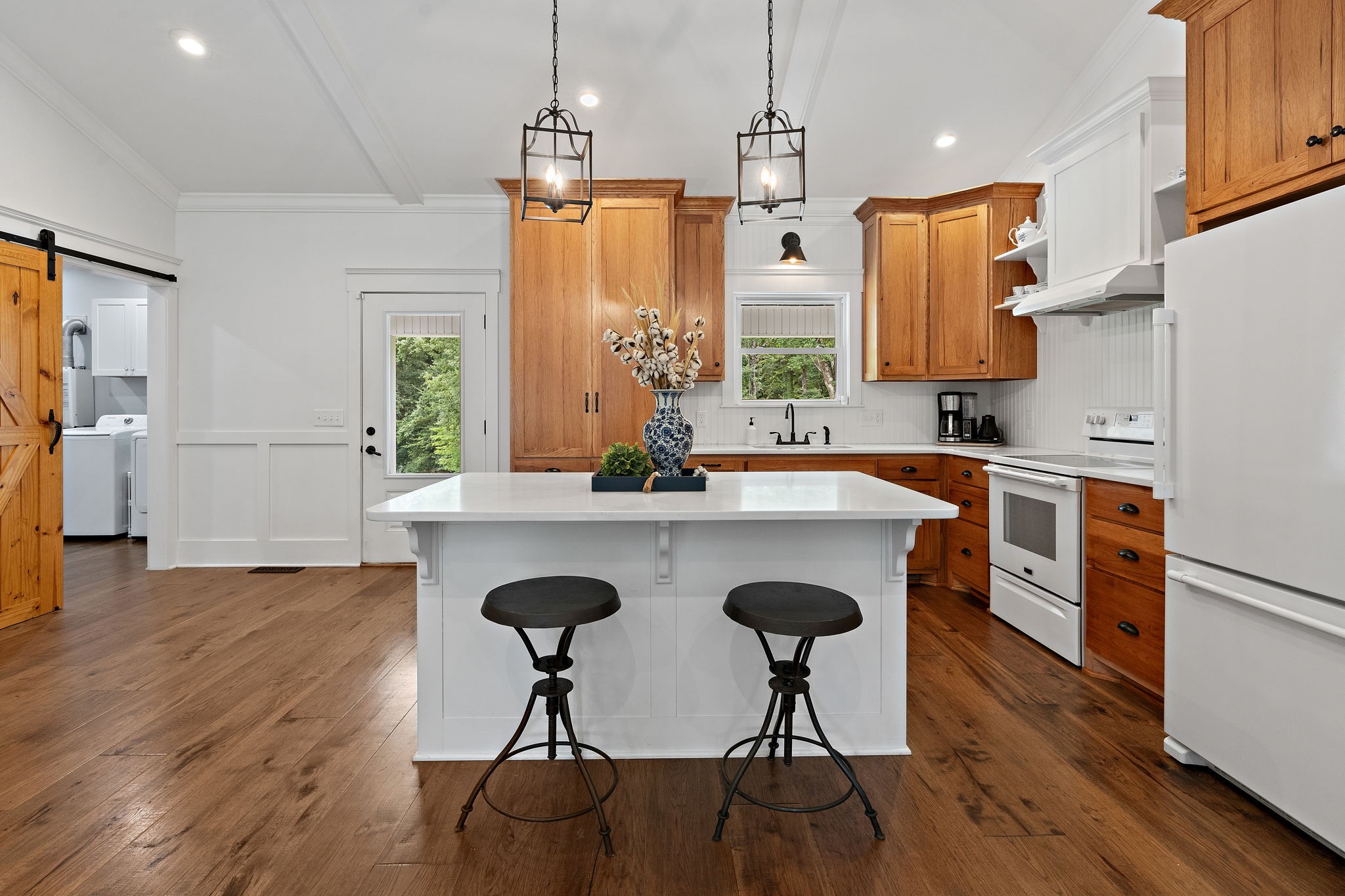2379 White Bluff Road Burns, TN 37029 - Photo 8 of 40 a kitchen with stainless steel appliances a dining table chairs a sink and dishwasher a refrigerator with wooden floor