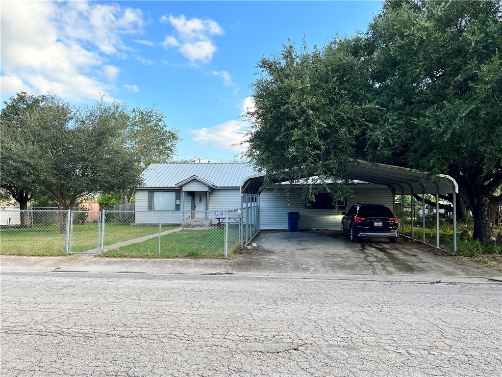 305 East Laredo Street Freer, TX 78357 - Photo 1 of 19 a view of backyard with a table and chairs under an umbrella