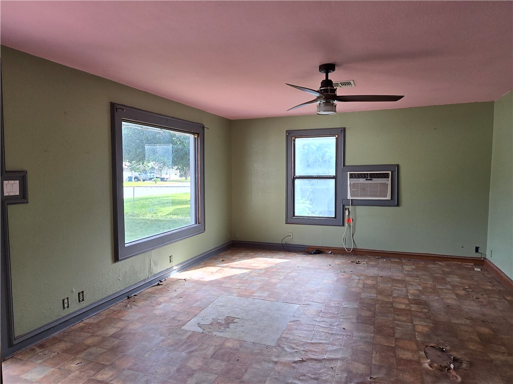 305 East Laredo Street Freer, TX 78357 - Photo 9 of 19 an empty room with windows and fan