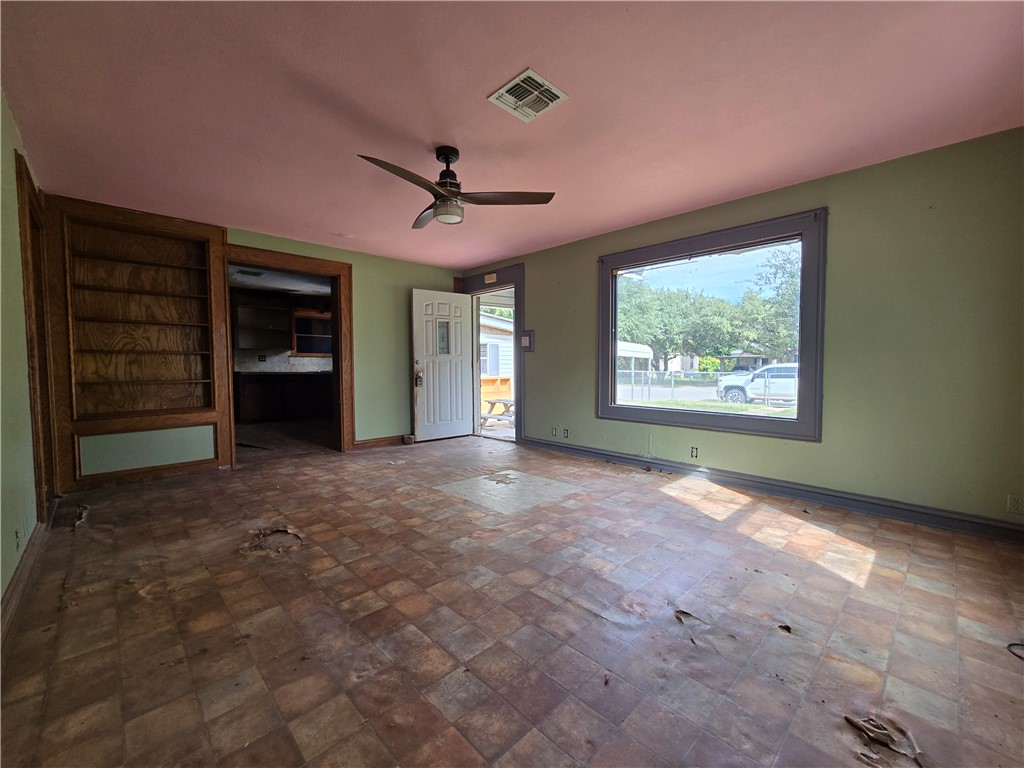 305 East Laredo Street Freer, TX 78357 - Photo 10 of 19 a view of a livingroom with a ceiling fan and window