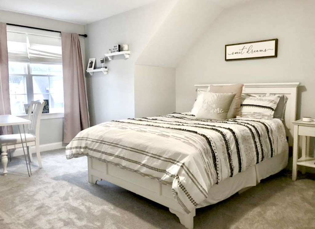 140 Red Fox Run Wrentham, MA 02093 - Photo 17 of 26 a bed sitting in a bedroom next to a window