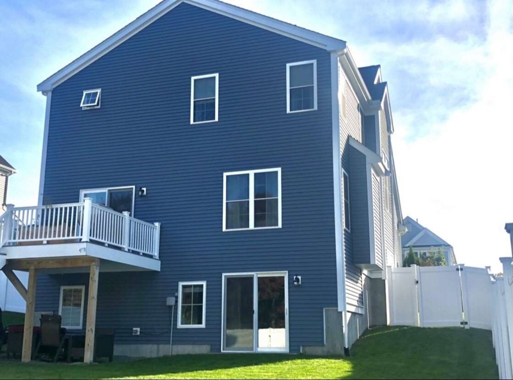 140 Red Fox Run Wrentham, MA 02093 - Photo 2 of 26 a front view of a house with yard and green space
