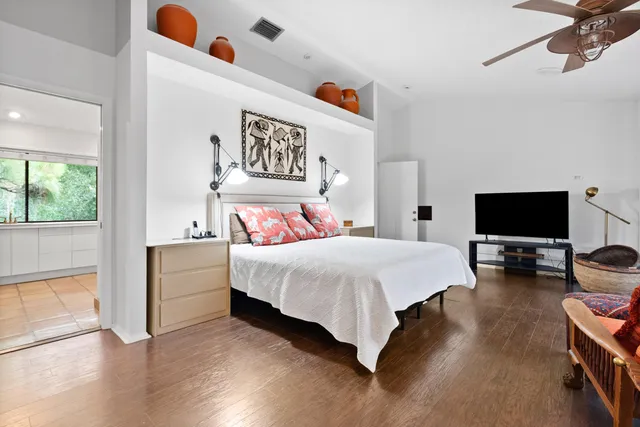 a bedroom with a bed and a flat screen tv