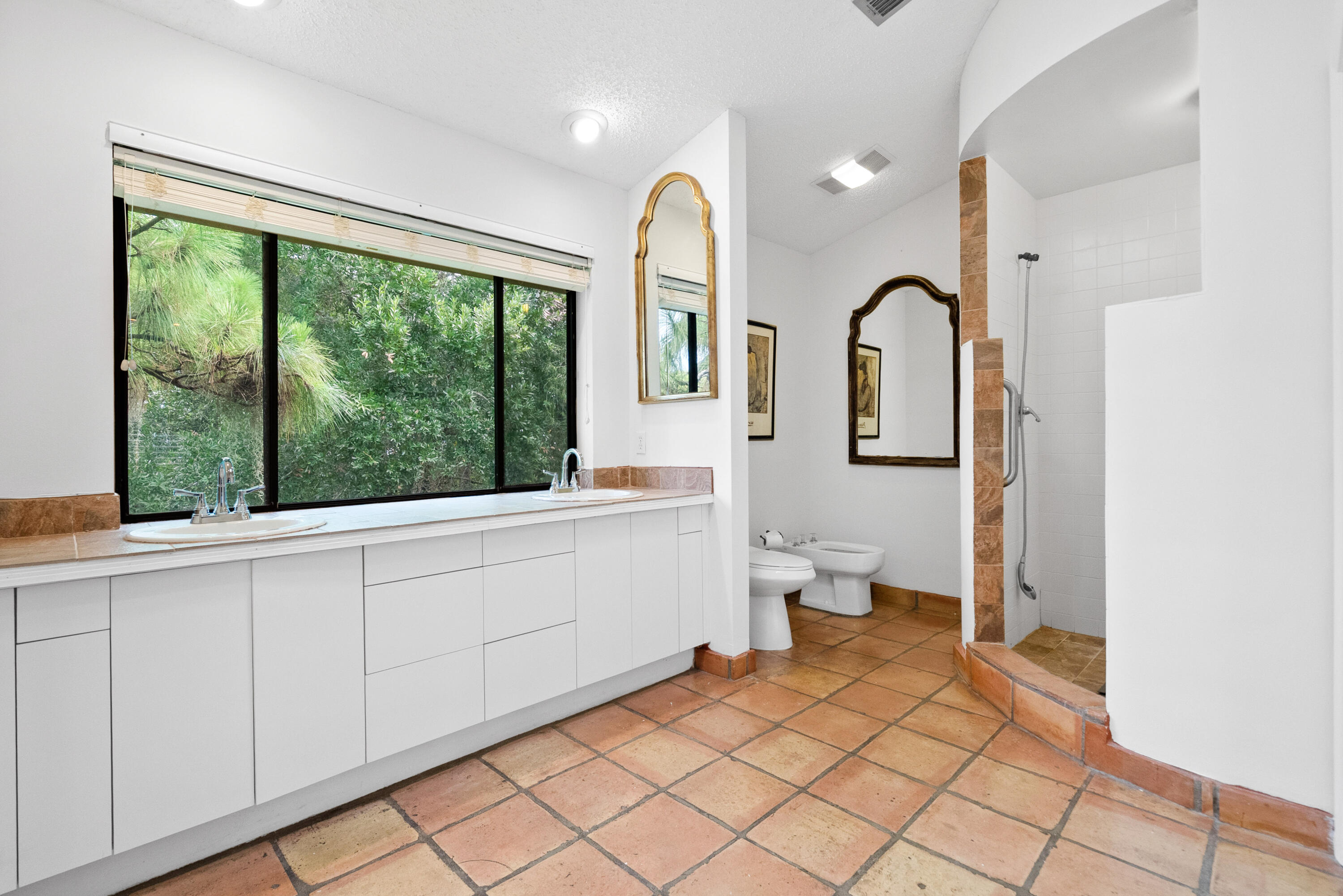 3217 Northwest Perimeter Road Palm City, FL 34990 - Photo 13 of 64 a spacious bathroom with a toilet sink and mirror