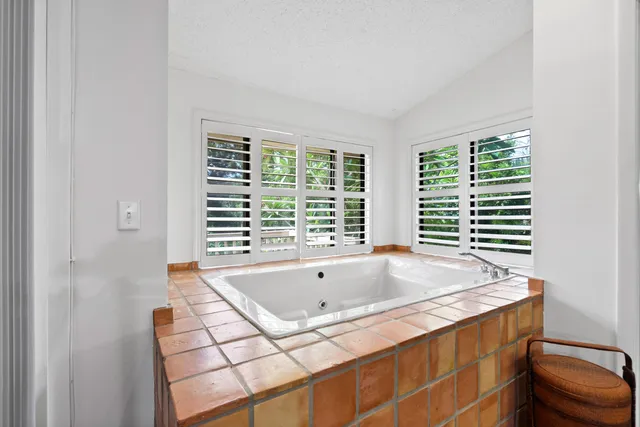 a bath tub sitting in a bathroom next to a window