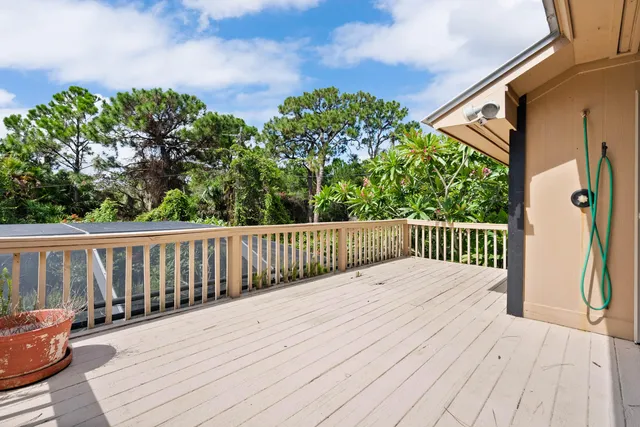 a dining room with furniture and a floor to ceiling window