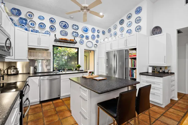 a kitchen with granite countertop a sink and appliances