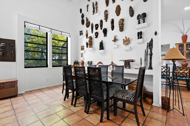 a view of a patio with table and chairs under an umbrella