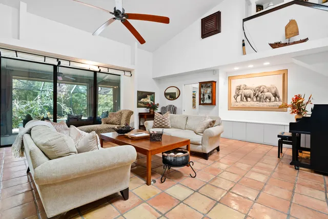 a living room with furniture and a floor to ceiling window