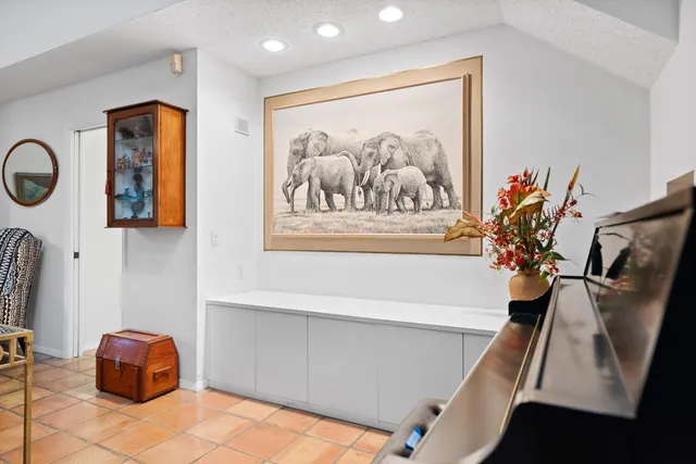 a view of patio with a table and chairs under an umbrella