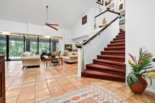 a living room with furniture and a floor to ceiling window