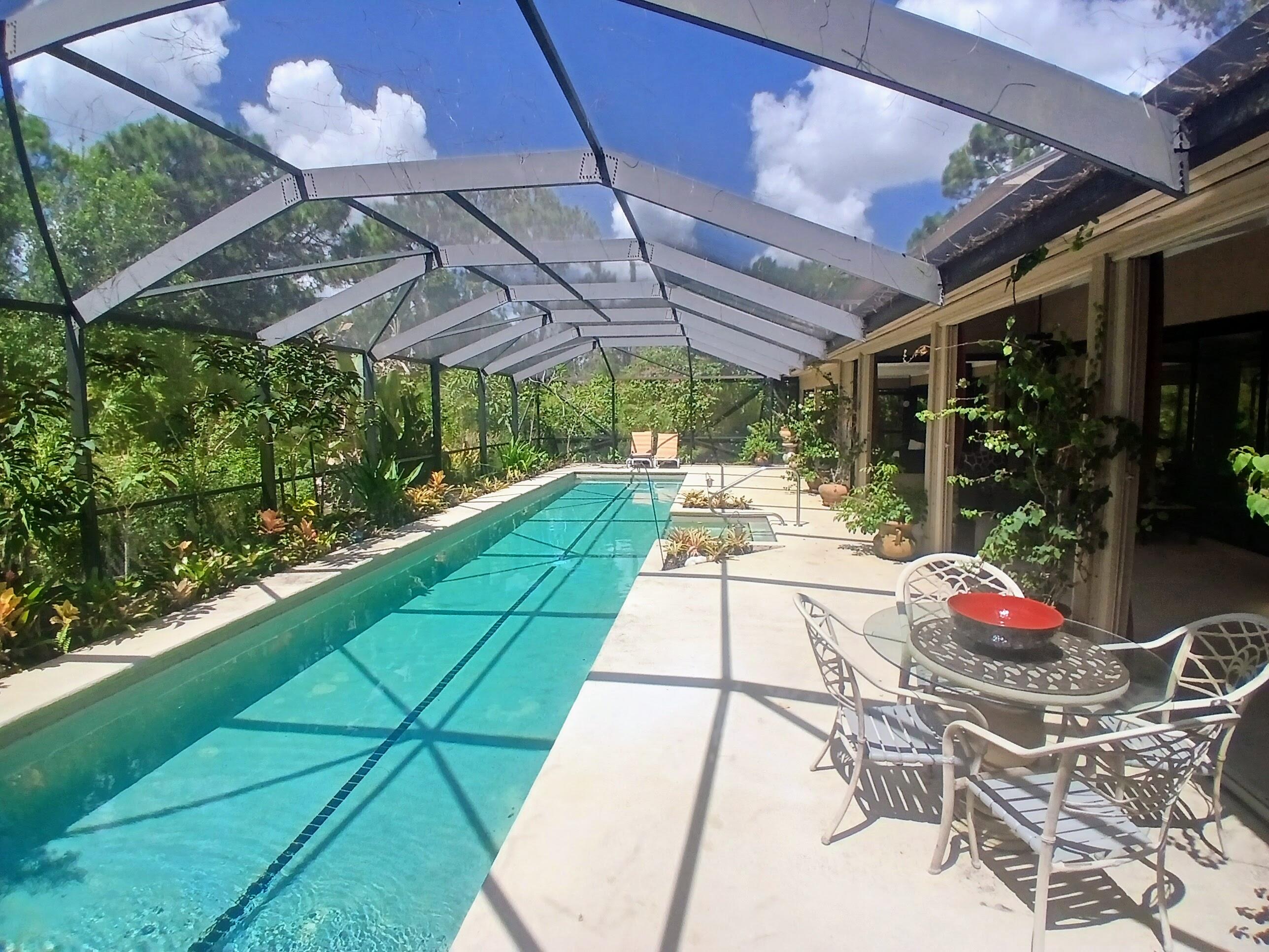 3217 Northwest Perimeter Road Palm City, FL 34990 - Photo 32 of 64 a view of patio with a table and chairs under an umbrella