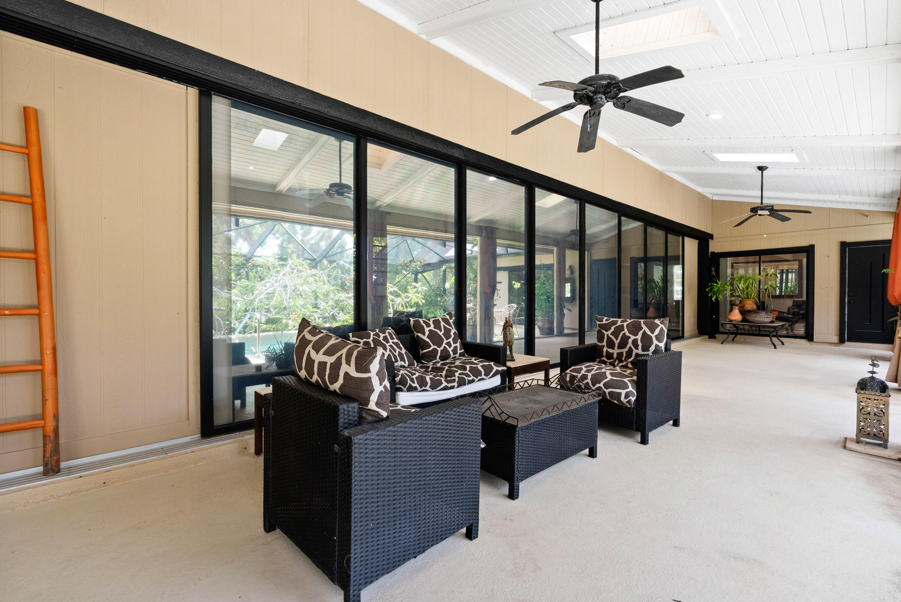 3217 Northwest Perimeter Road Palm City, FL 34990 - Photo 35 of 64 a living room with furniture and a floor to ceiling window